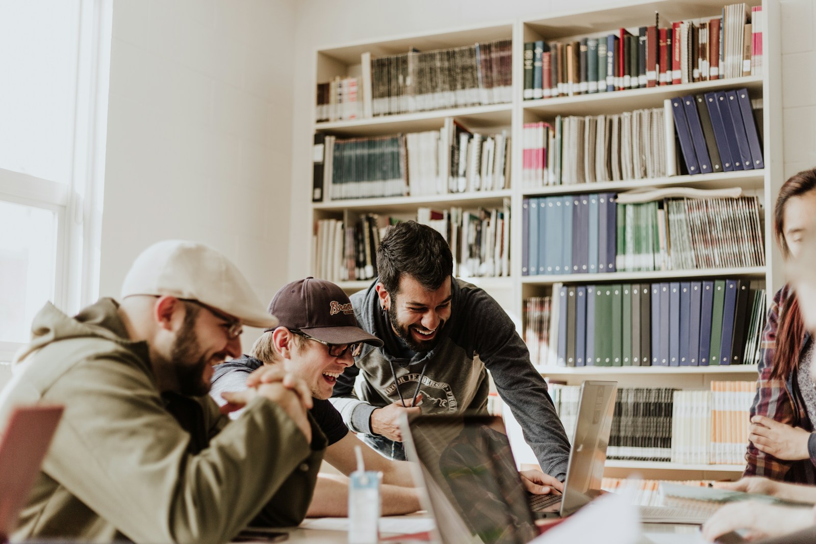 A group of young adults collaborating around a study table